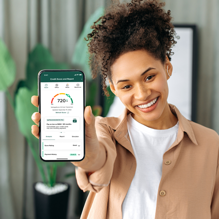 Woman with phone showing credit score screen